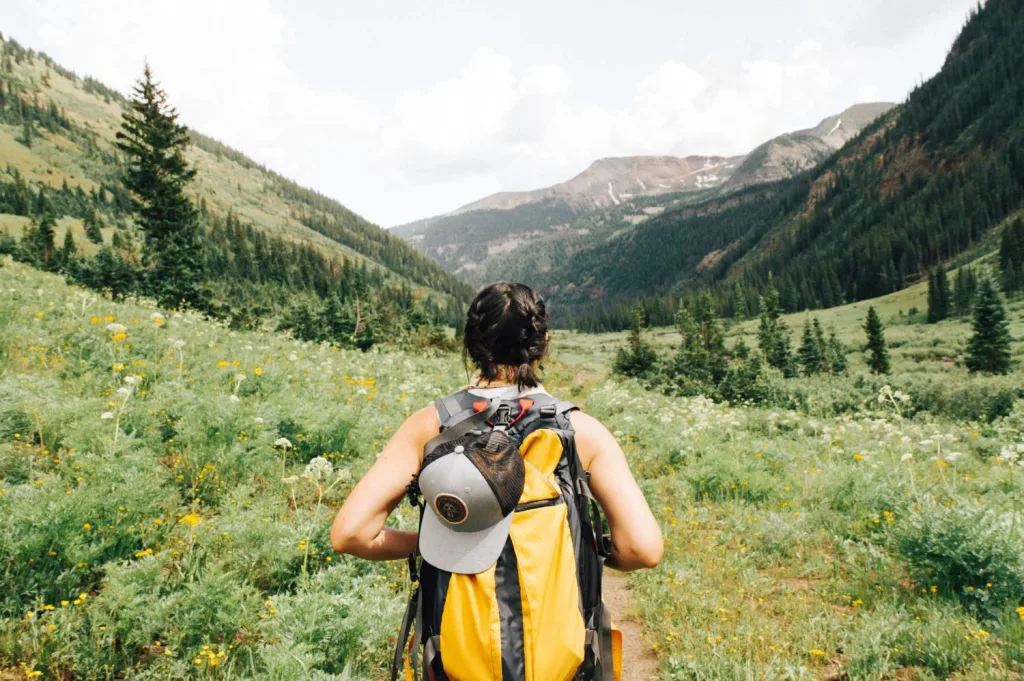 solo female hiker with yellow backpack